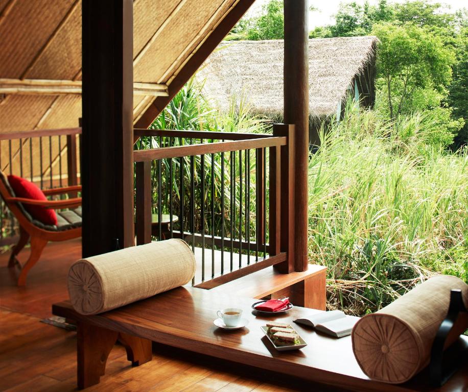 a room with a balcony with a table and chairs at Jetwing Vil Uyana, A Luxury Reserve in Sigiriya