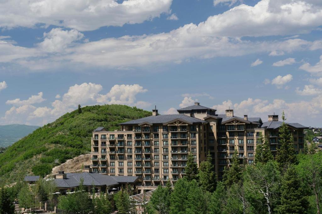 a large apartment building on top of a hill at St. Regis Deer Valley in Park City