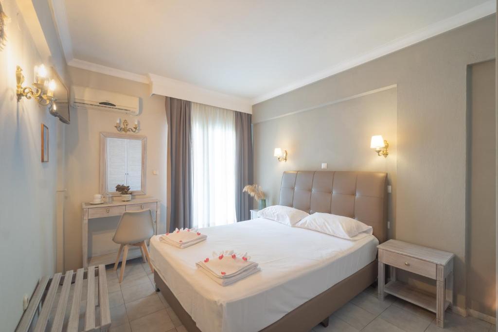 a bedroom with a bed with two cakes on it at Mironi & Victoria in Limenas