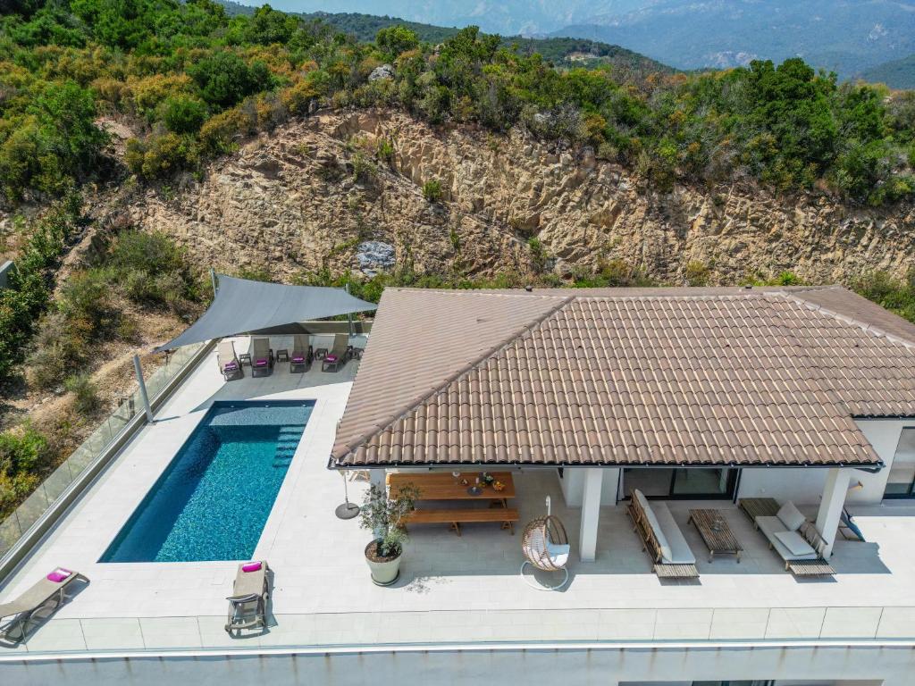 an aerial view of a house with a swimming pool at villa mare d'argentu - vue mer panoramique in Sari Solenzara