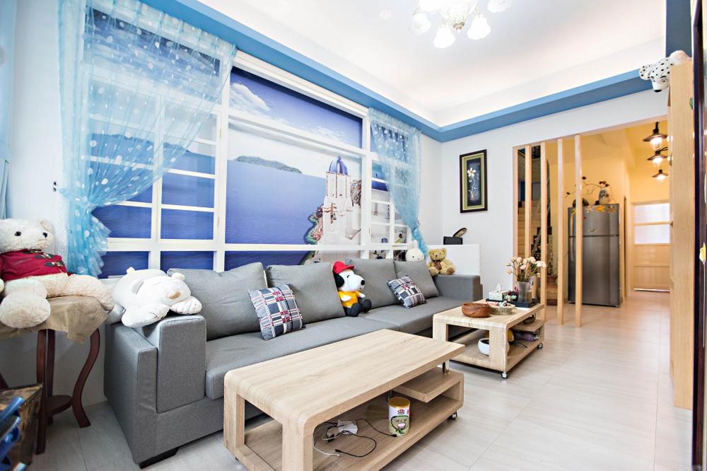 a living room with a gray couch and a large window at 微旅行Micro Travel in Guanshan