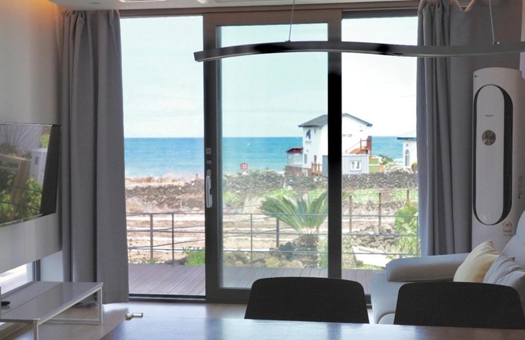 a living room with a view of the ocean at Aewol Bada 24 in Jeju