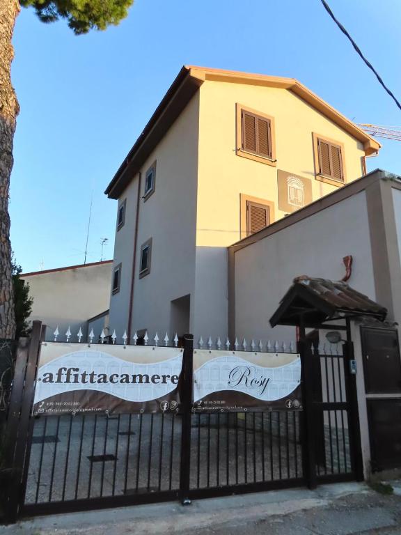 a black fence in front of a building at Affittacamere Rosy in Foligno