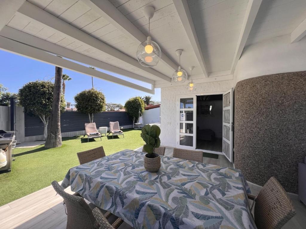 a dining room with a table and chairs on a patio at Suite Coco in Maspalomas