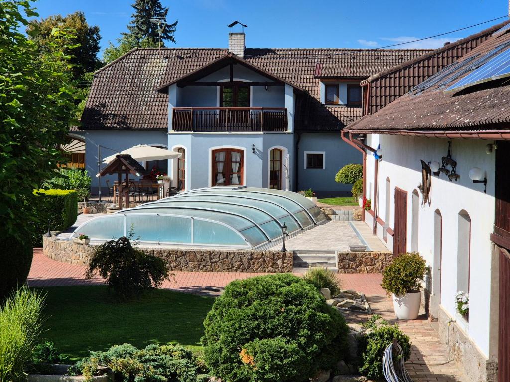a house with a swimming pool in the yard at Apartmány Močovice in Močovice