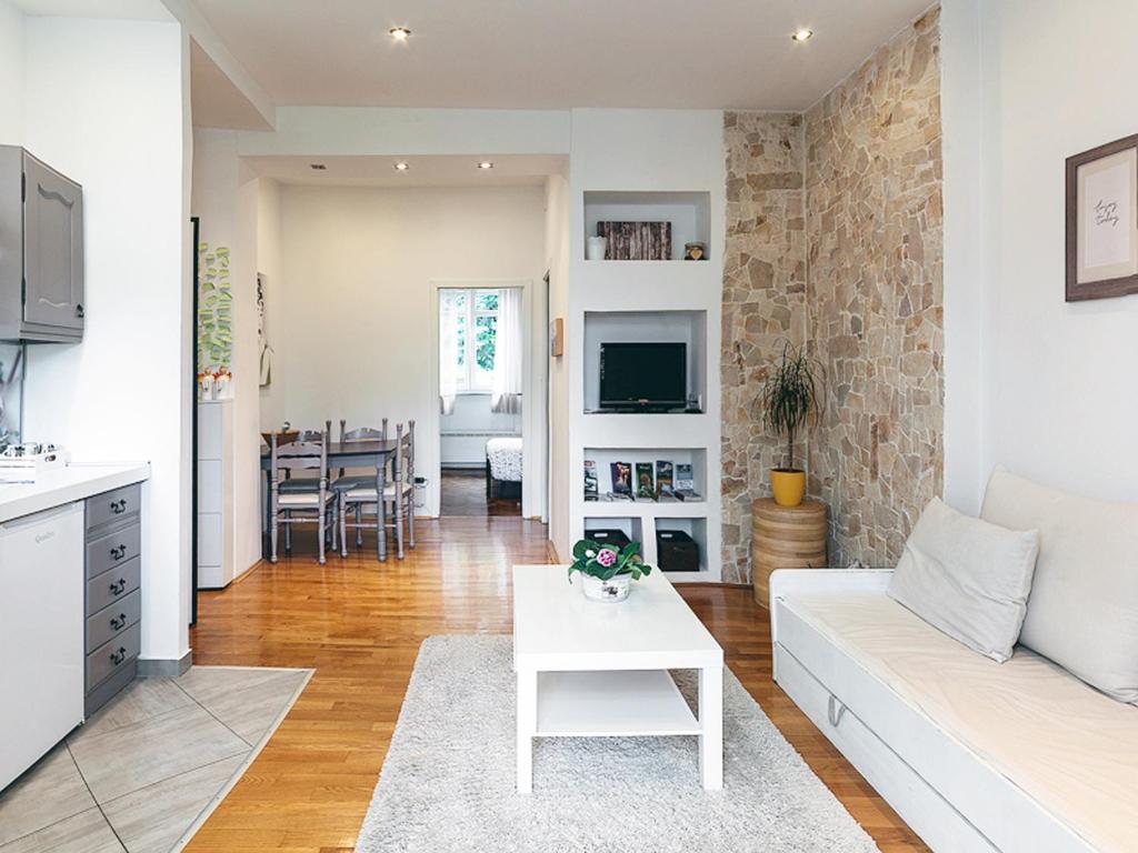 a living room with a white couch and a table at Charming Apartment in Zagreb