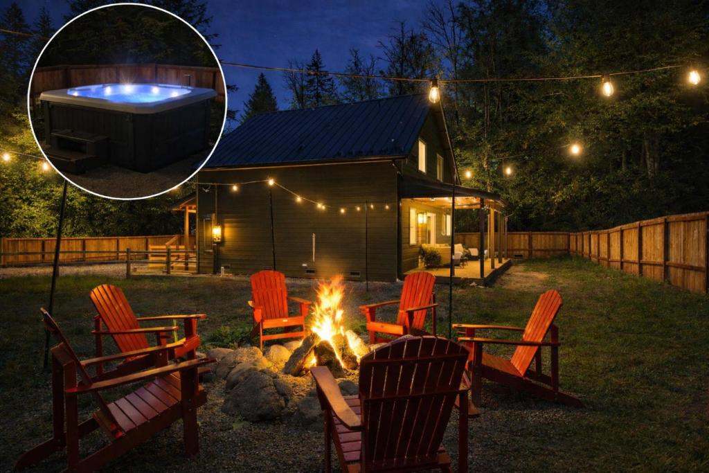 a fire pit in a yard with chairs and a hot tub at Forest Haven in Ashford