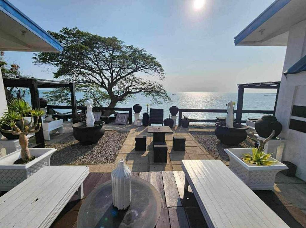 a patio with benches and a view of the ocean at Pio's Place Hidden Resort in Namonitan