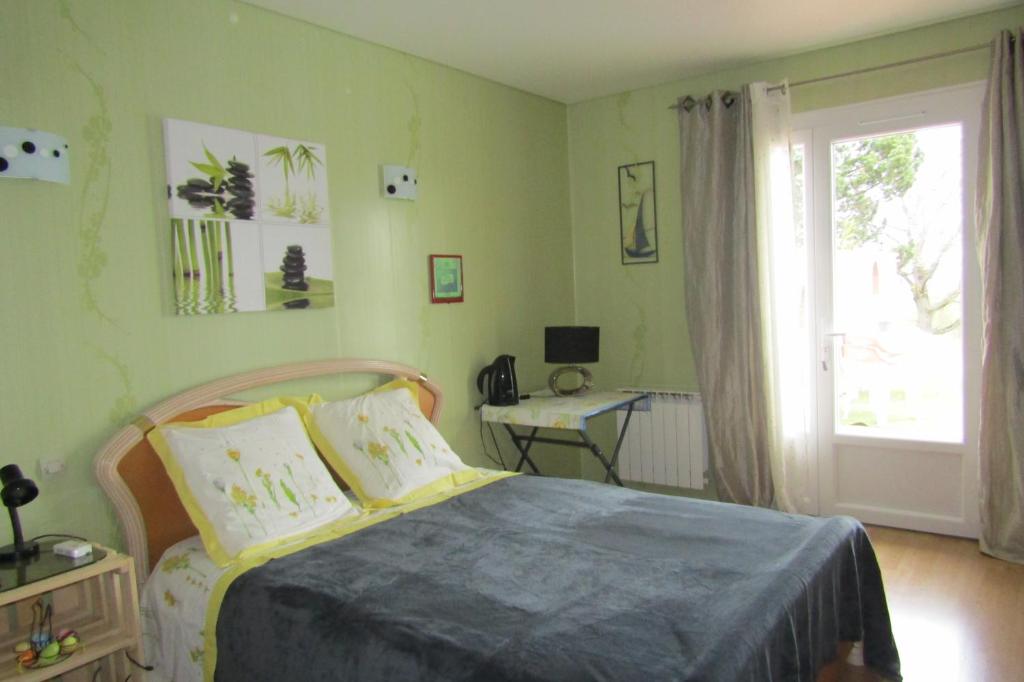 a bedroom with a bed and a desk and a window at Galinat in Culmont