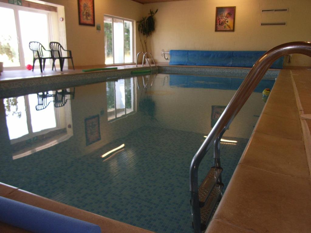 a swimming pool in a building with a pool at Ivy Tower Cottages in Saint Florence