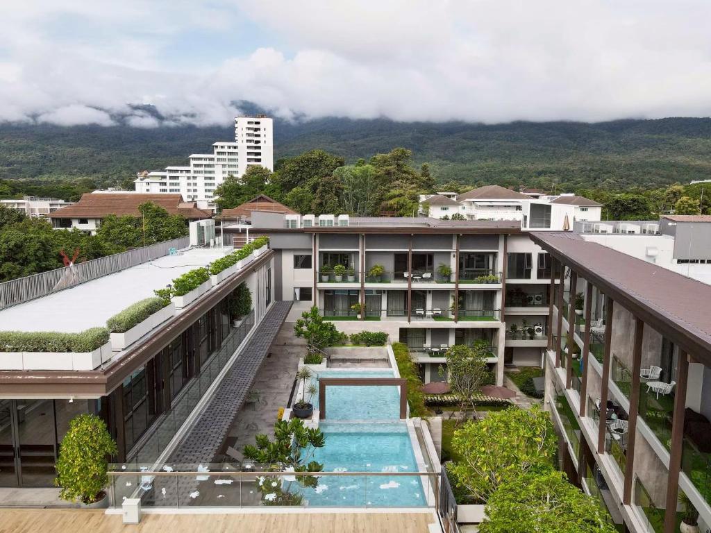 an external view of a building with a swimming pool at Kasa Verdana in Chiang Mai