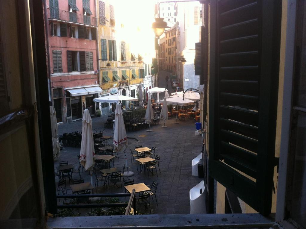 a view of a street with tables and umbrellas at Albergo Panson in Genova