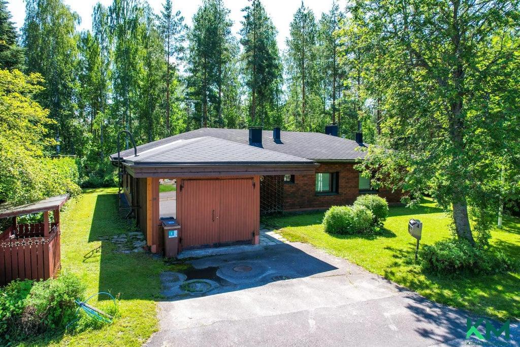 a small house with a garage in a yard at Nordic City Home in Lahti