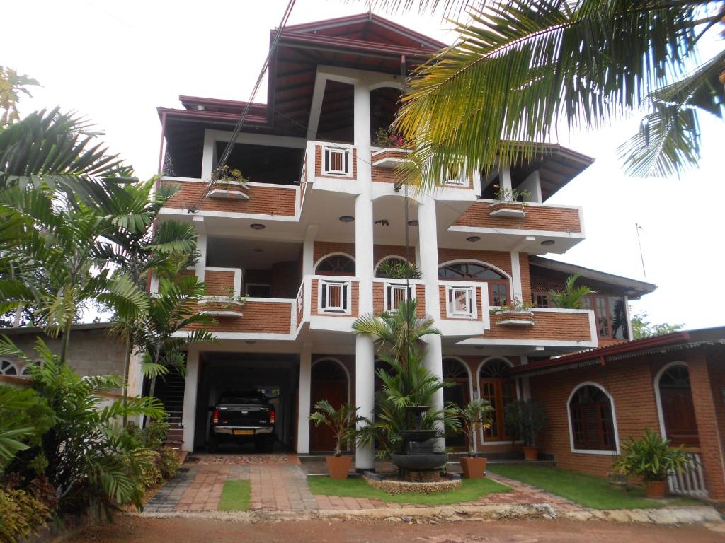 um edifício com palmeiras em frente em Melvila em Colombo