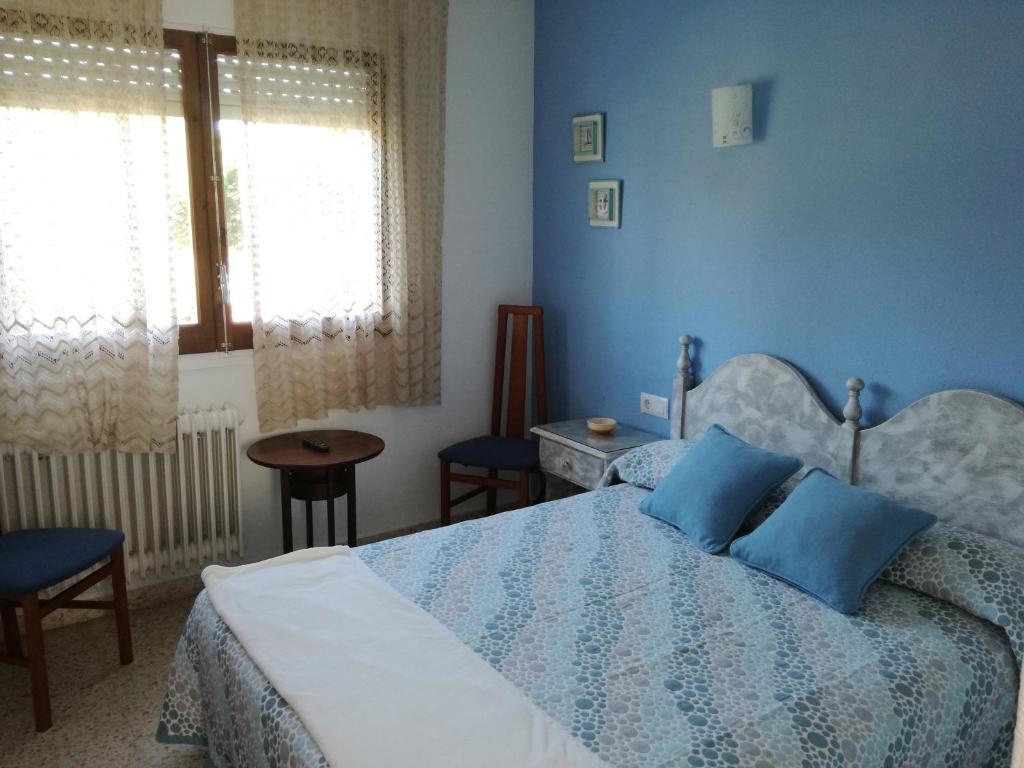 Postel nebo postele na pokoji v ubytování Hostal Los Pinares