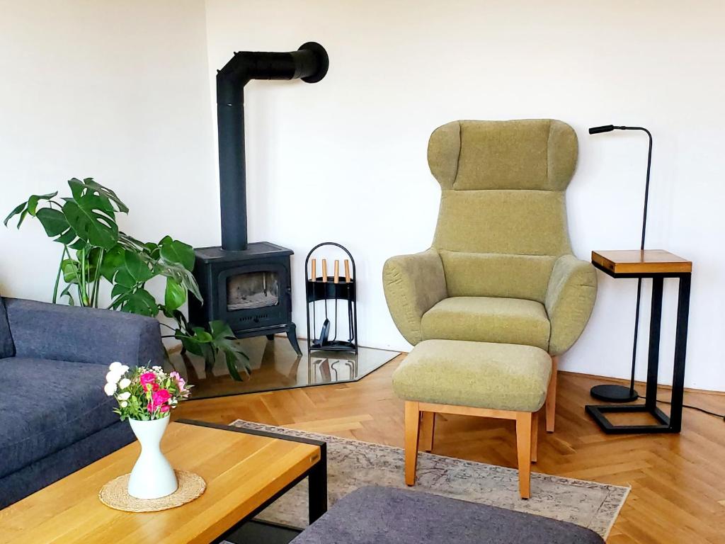 a living room with a couch and a chair and a stove at New apartment Eva in Jicin, 2 bedrooms and balcony, Czech Paradise in Jičín