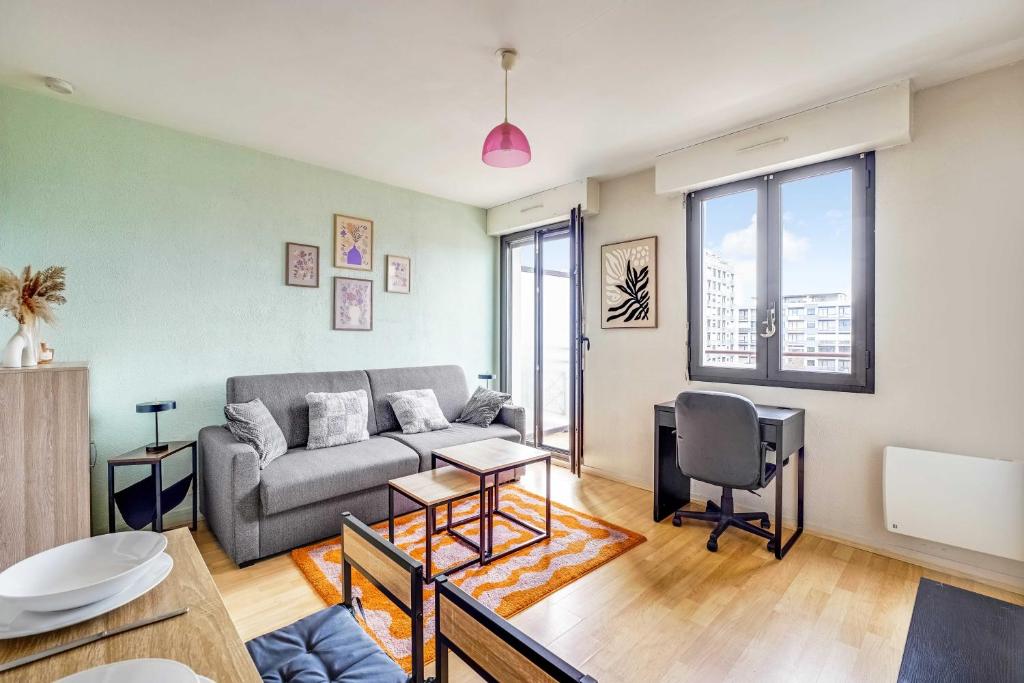 a living room with a couch and a table at Spacious Studio 2P - Near La Défense in Courbevoie