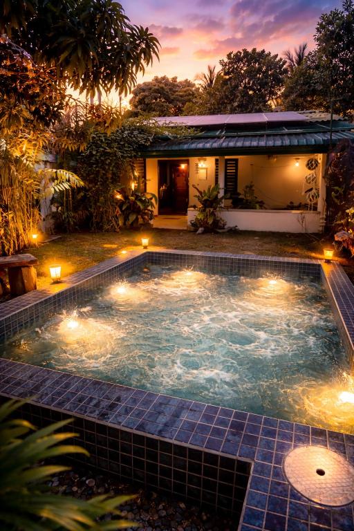 a swimming pool with lights in front of a house at New! Mangalam house, Private plunge pool near beach in Trincomalee