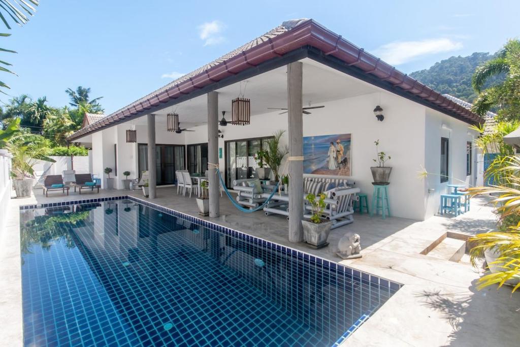 a villa with a swimming pool and a house at Southern Lanta C9 in Ko Lanta