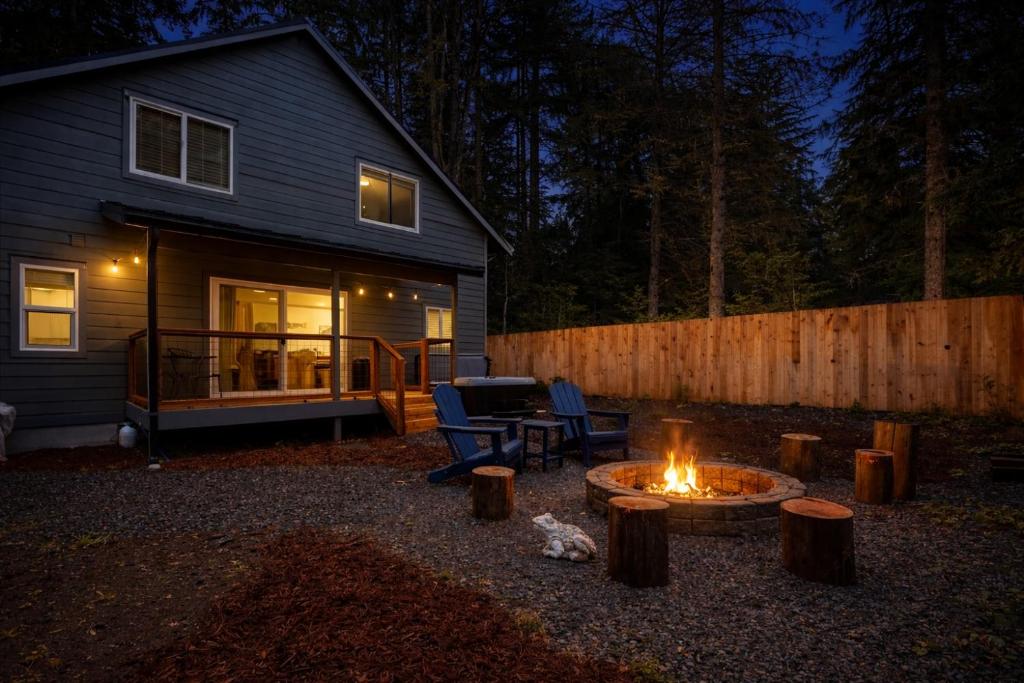 a backyard with a fire pit and a house at Perch - Mowich Cozy in Ashford
