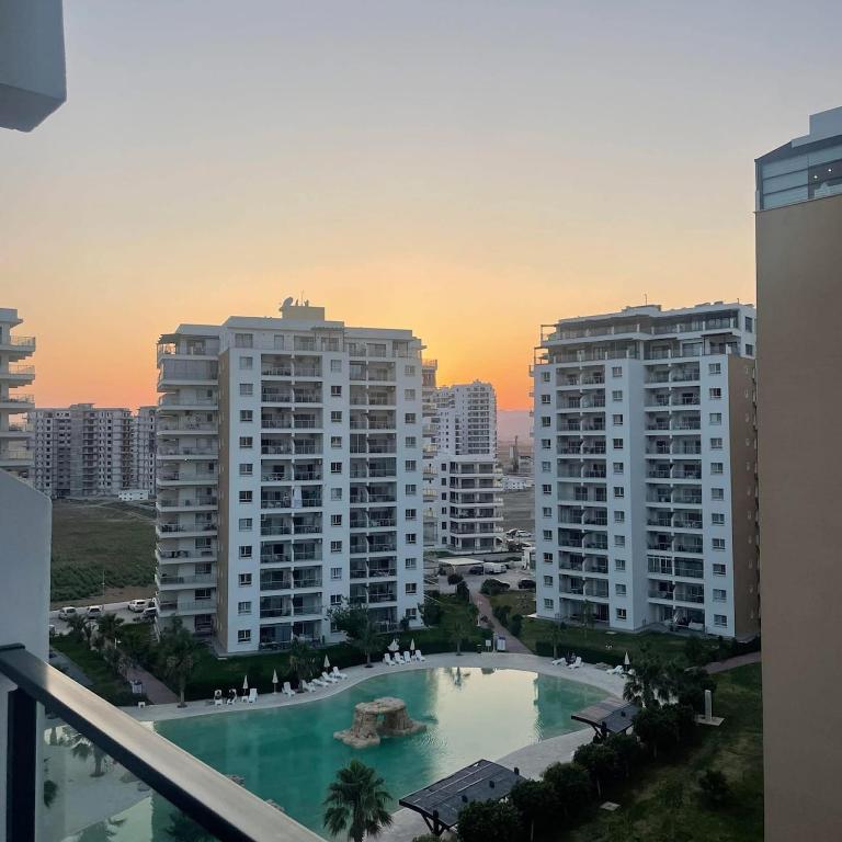 a view of a pool in a city with buildings at Pool View Studio Apartment Caesar Resort & Spa in Dherinia