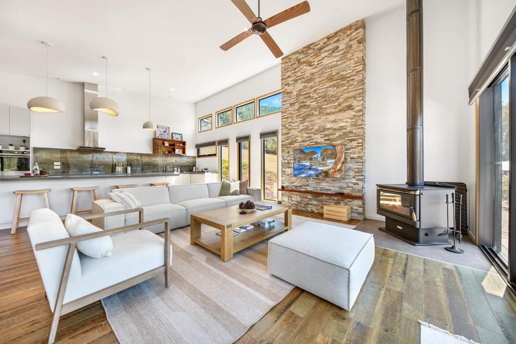 a living room with a couch and a fireplace at Bright Vista with Studio in Bright