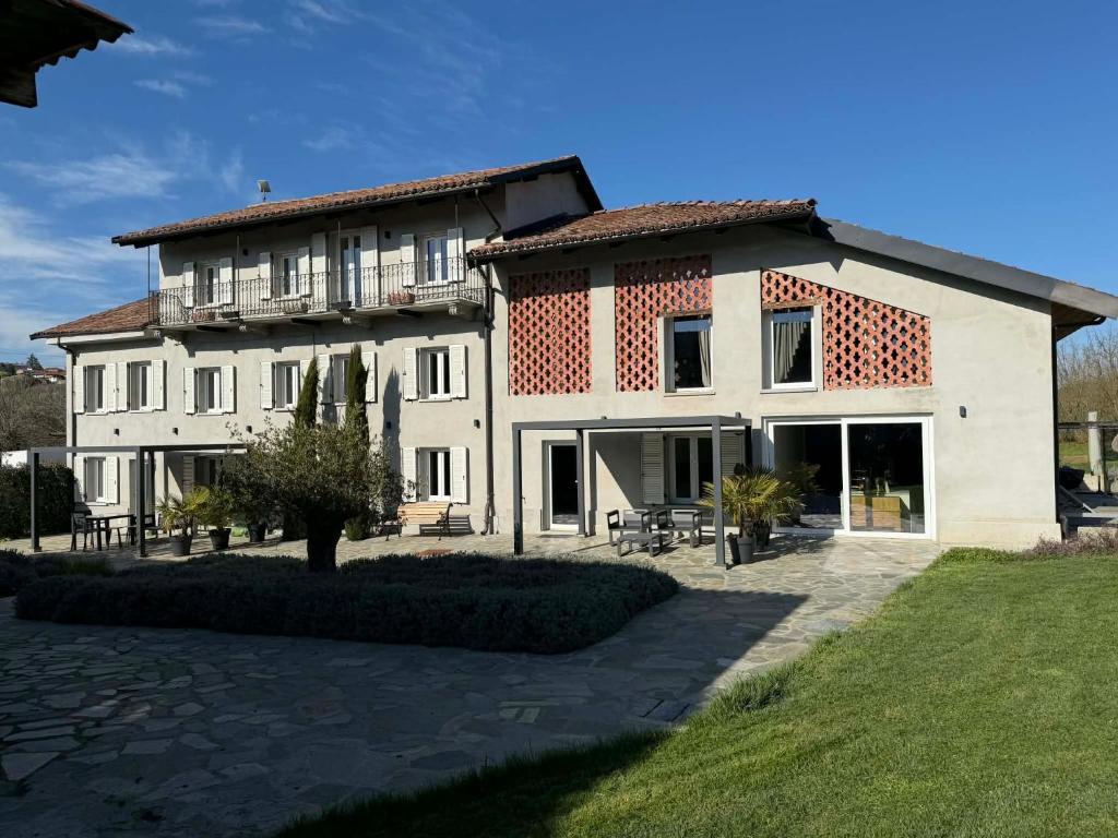 a large white building with a lot of windows at Sogno La Vigna - Adults Only in Montegrosso dʼAsti