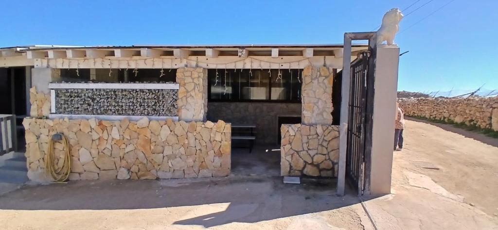 a gate to a building with a bunch of fire wood at Lampedusa da Sogno 1 in Lampedusa