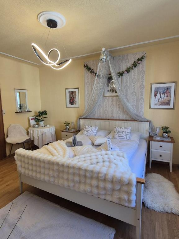 a bedroom with a large bed with a canopy at Zum Blumentritt in Sankt Aegyd am Neuwalde