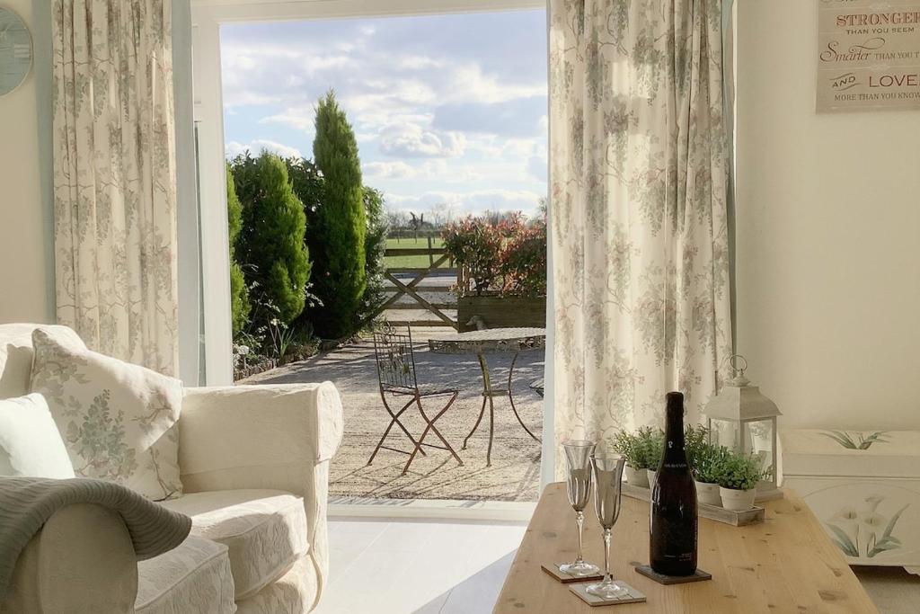 a living room with a view of a patio at The Meadows, OXTED in Tandridge