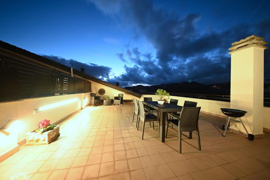 a patio with a table and chairs on a balcony at La Terrazza Sidicina Home in Teano