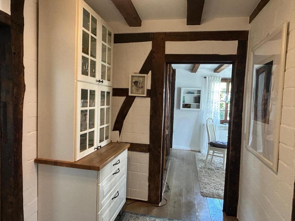 a kitchen with a door leading to a dining room at Fachwerkjuwel im Bergischen in Remscheid