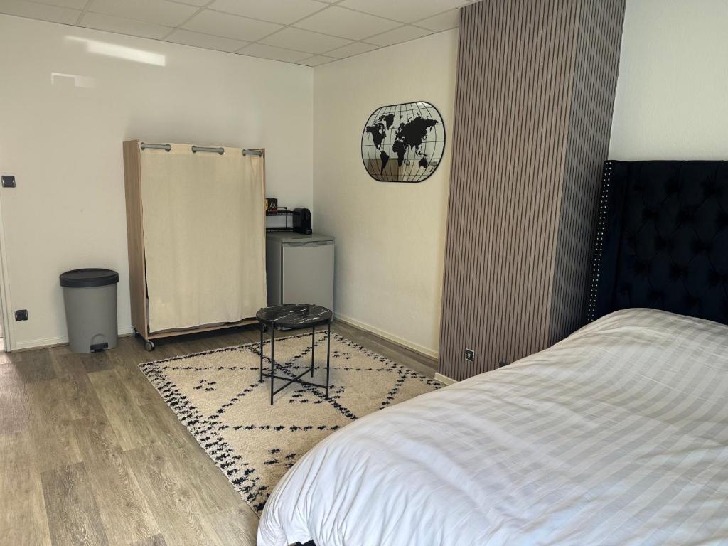 a bedroom with a bed and a chair in it at Studio in Remiremont