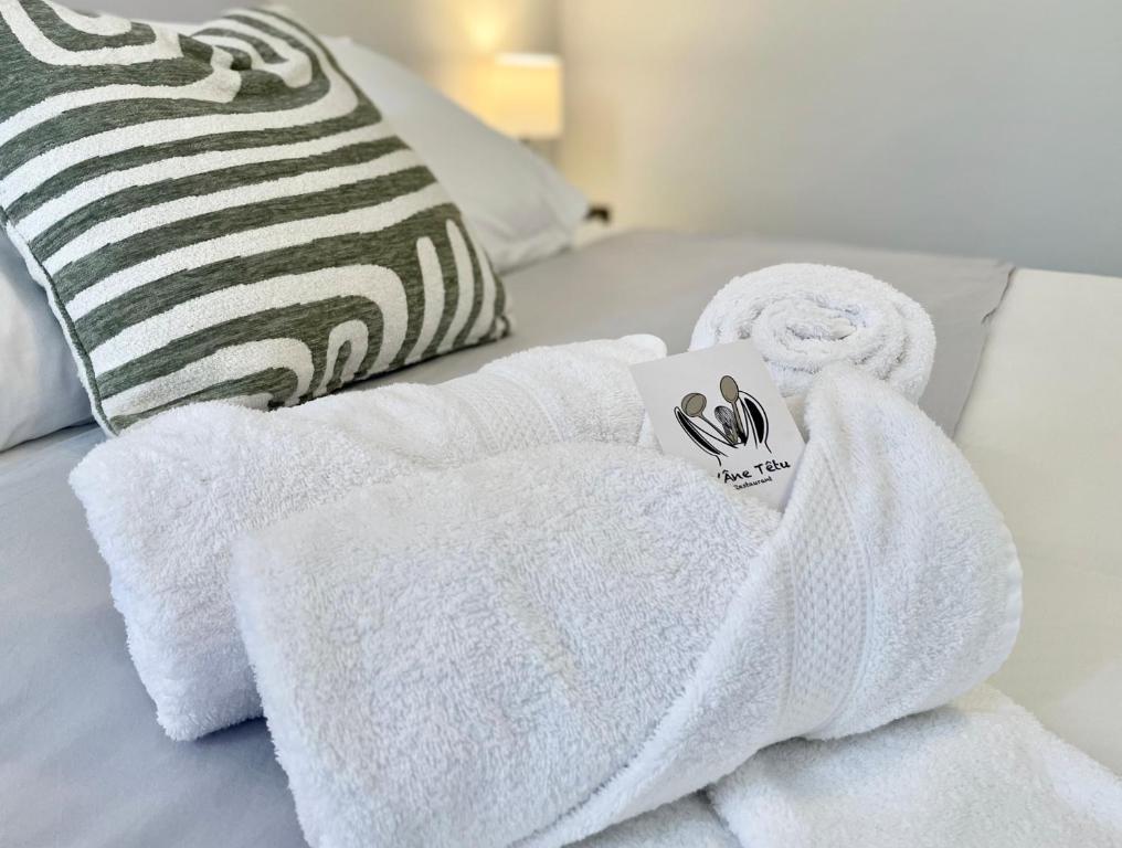 a pile of towels sitting on top of a bed at LAne Têtu in Désaignes