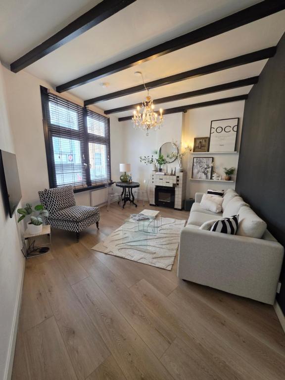 a living room with a couch and a table at Tip &Top Deluxe Appartement in Vlissingen