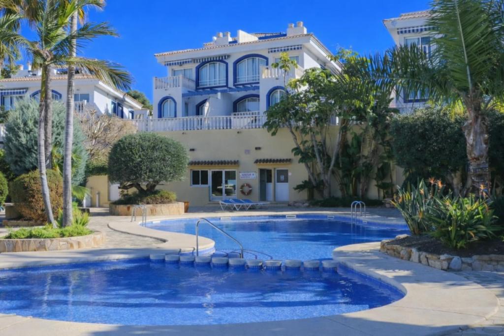 a large house with a swimming pool in front of it at Casanova 20G Calpe - Ifach Holiday Homes in Calpe