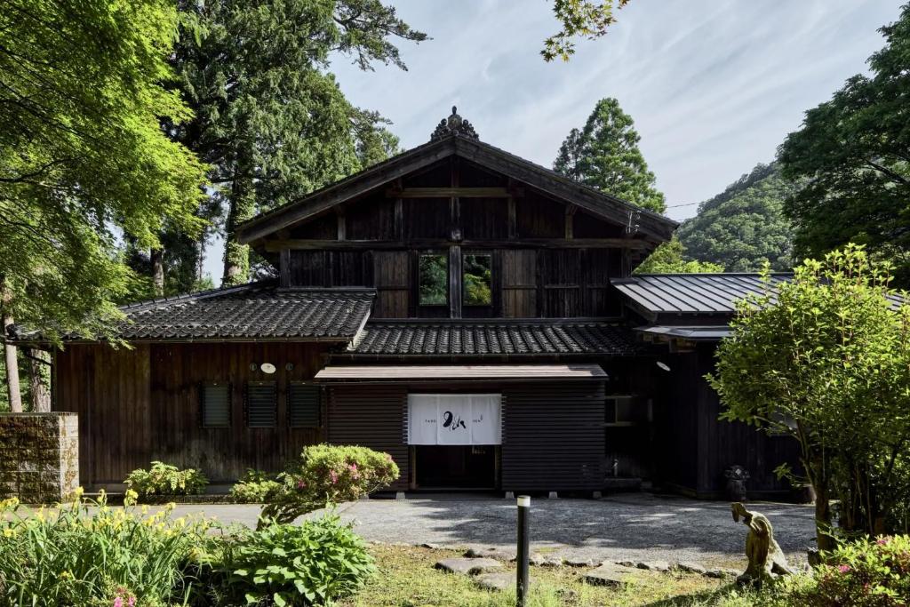 a large wooden building with a white garage at YADO SEN -仙- Komatsu in Komatsu