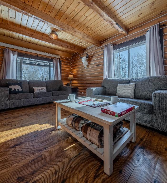 a living room with a couch and a coffee table at 20 mins to YNP-Cabin-Pet friendly in Island Park