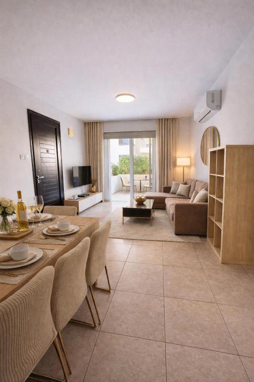 a living room with a couch and a table at Amigos Apartment Mythical in Protaras