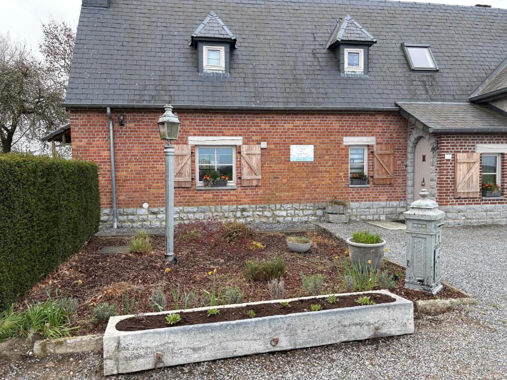 a house with a garden in front of it at La maison des Grands Vents in Ychippe