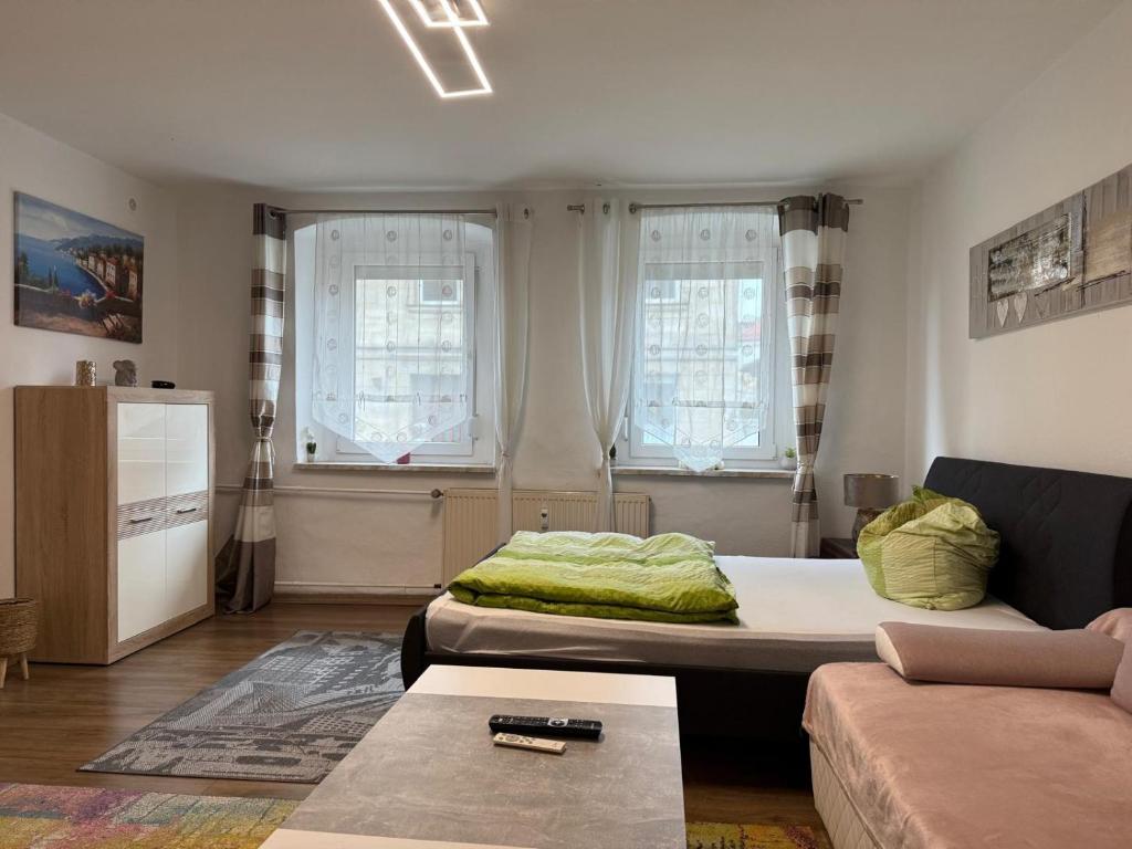 a living room with a bed and a couch at City Ferienwohnung Bayreuth in Bayreuth