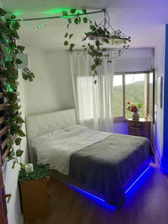 a bedroom with a bed with a blue led lighting at habitacion a 15 min playa d aro in Romanyá de la Selva