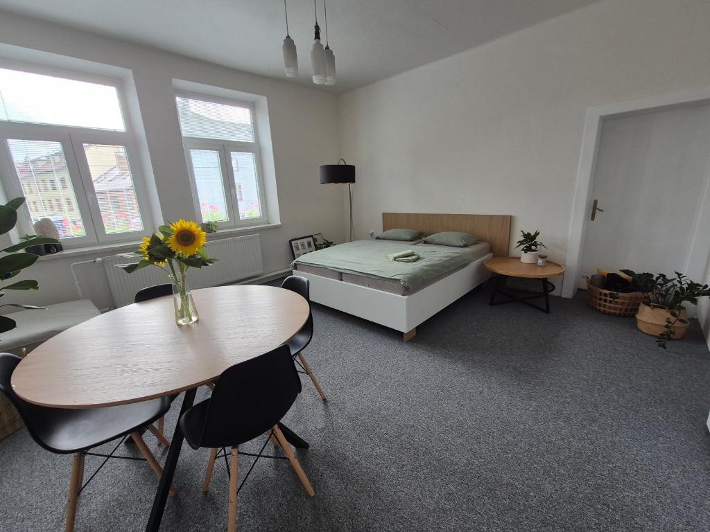 a bedroom with a bed and a table and chairs at LP 1926 aneb U nás doma in Zlín