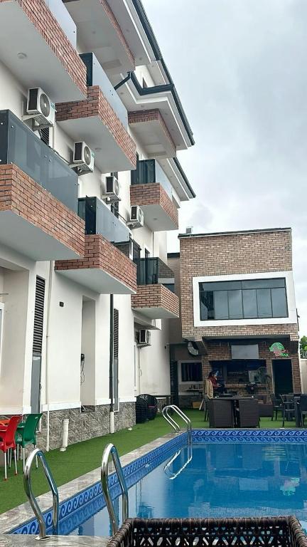 a swimming pool in front of a building at Harmony Villa in Nnewi