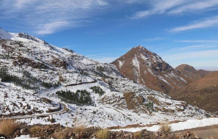a snow covered mountain with a road on it at gite ogog tachedirt in Tacheddirt