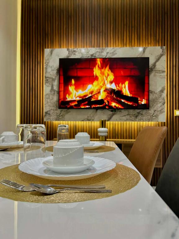 a dining table with a fireplace in the background at Appart Hôtel Stade Tanger in Tangier