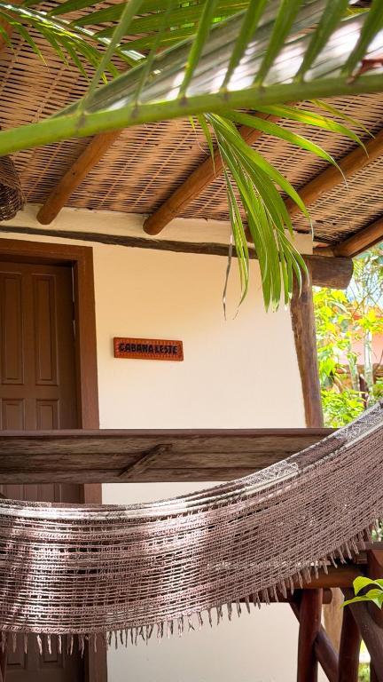 a hammock in front of a house at Vila Alta Caraíva in Caraíva