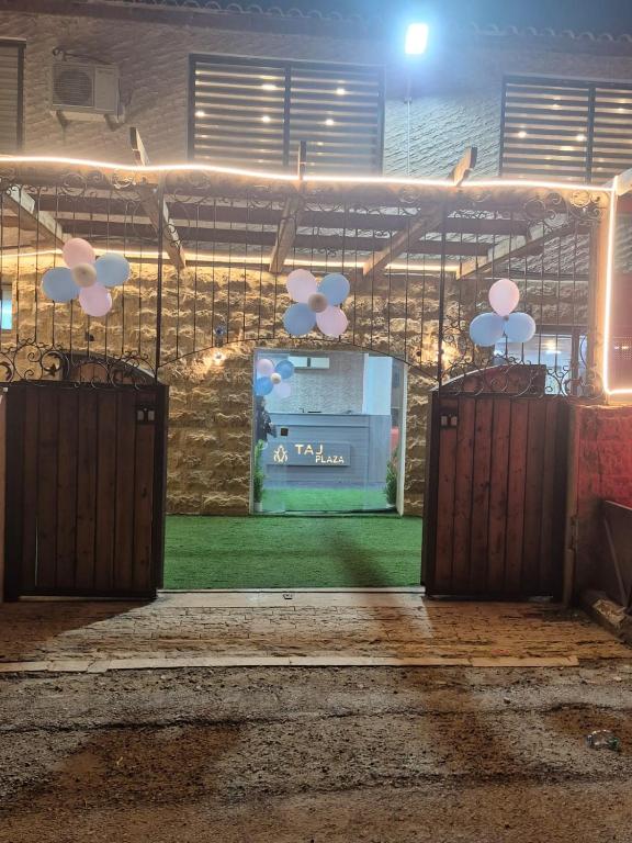 a stage with two open doors with a sign on it at Taj Plaza in Sowayma