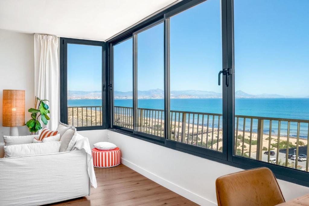 a living room with large windows overlooking the ocean at Luxury Beachfront "Felicità" Sea View 6 Guests in Arenales del Sol