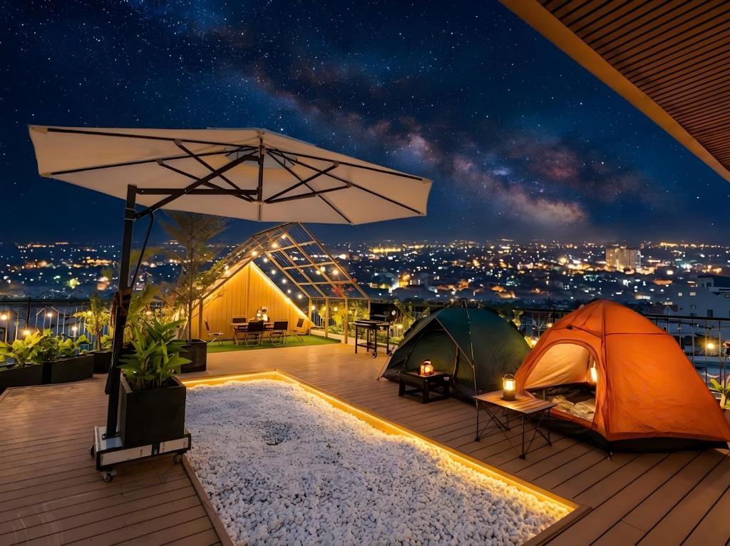a patio with tents and a view at night at Gió Villa in Ấp Sơn Hải
